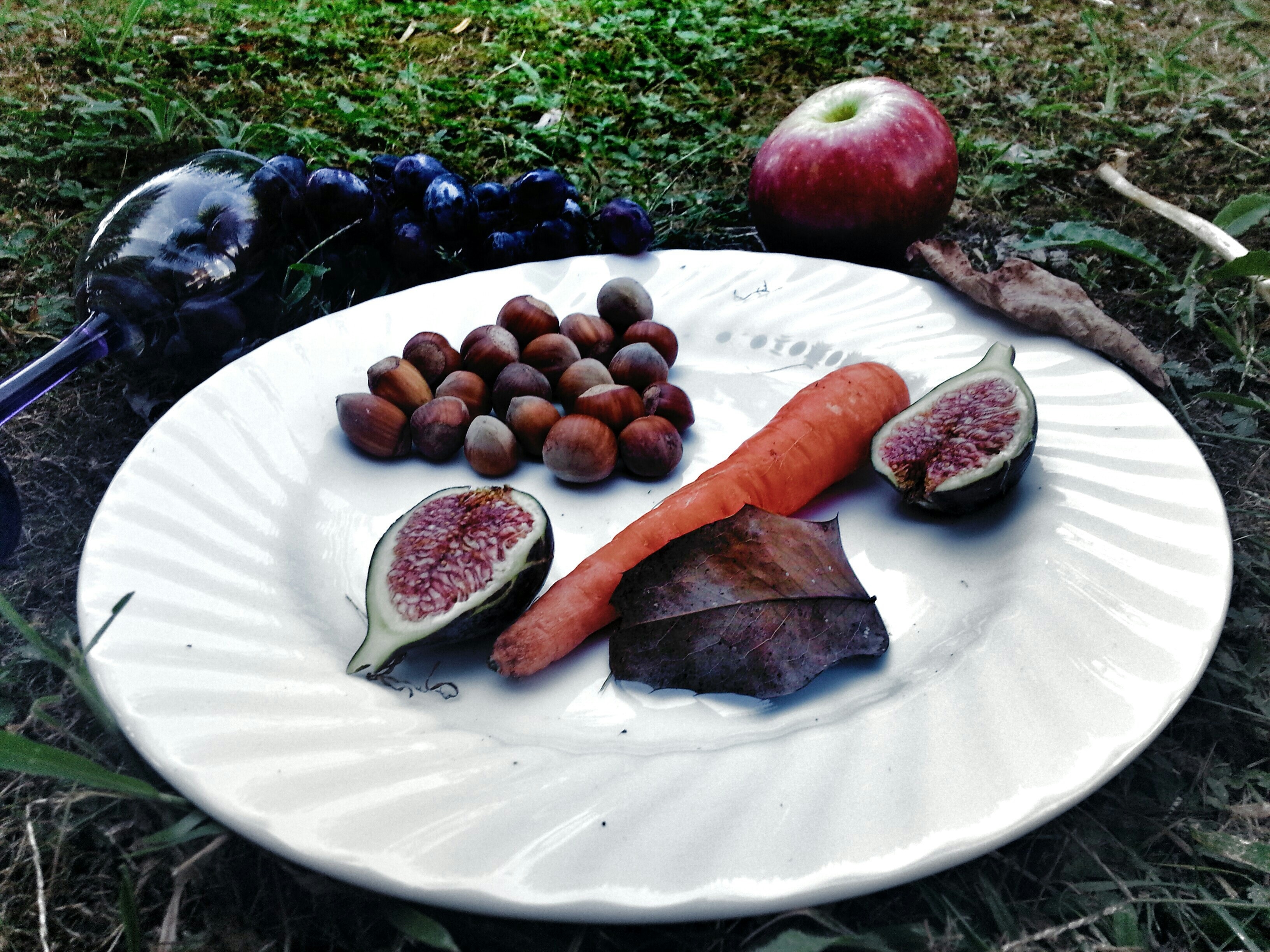 assorted vegetables and fruits on the plate with dark lighting