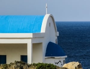 white and blue church near the sea photo thumbnail