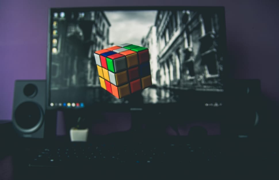 flat screen monitor turned on with 3x3 rubik's cube wallpaper preview