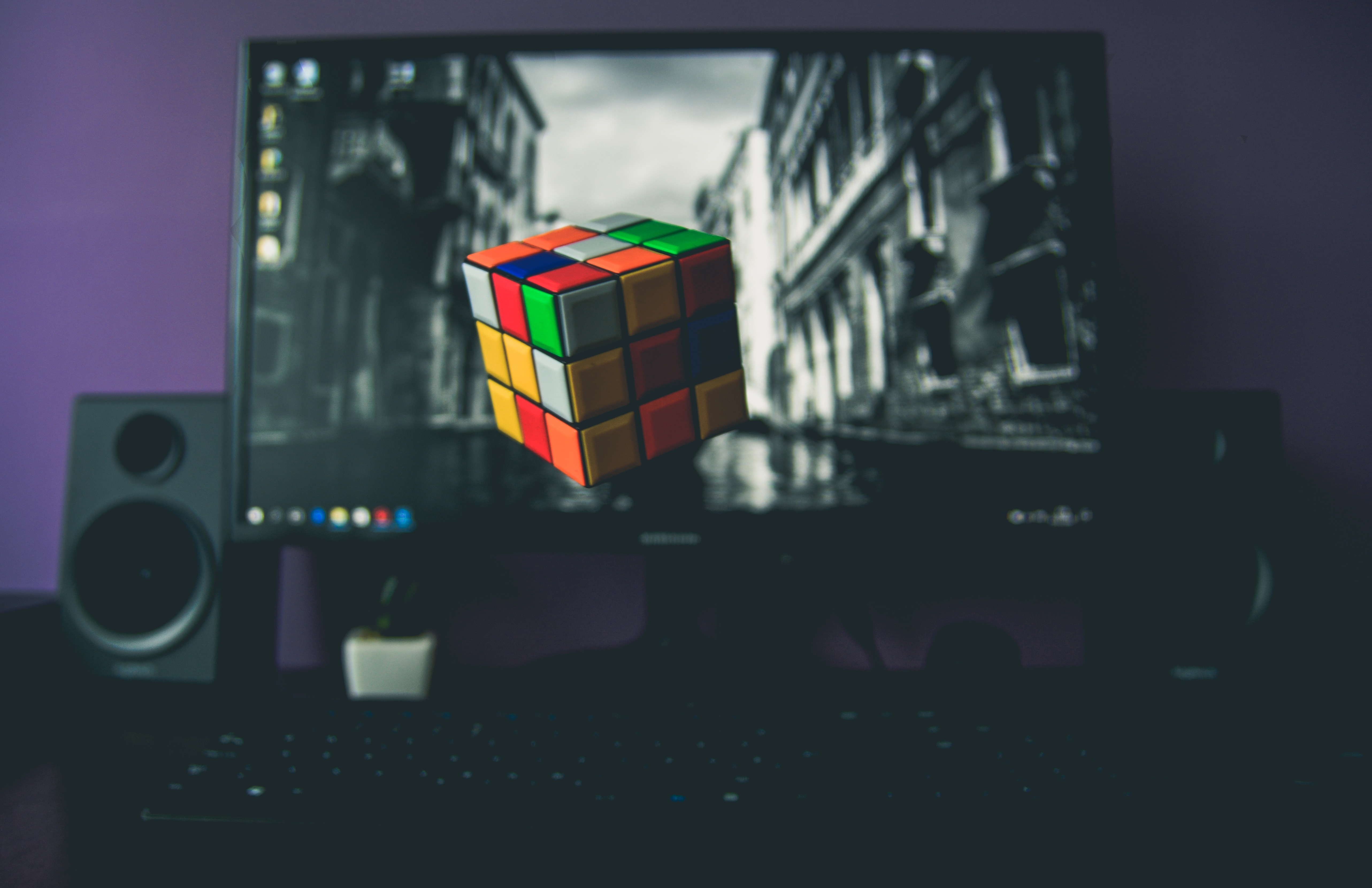 flat screen monitor turned on with 3x3 rubik's cube wallpaper