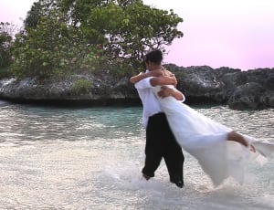 photography of two couple on top of body of water thumbnail