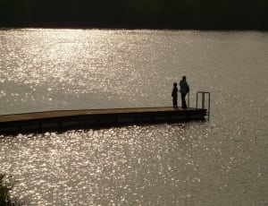 person and child standing on dock thumbnail