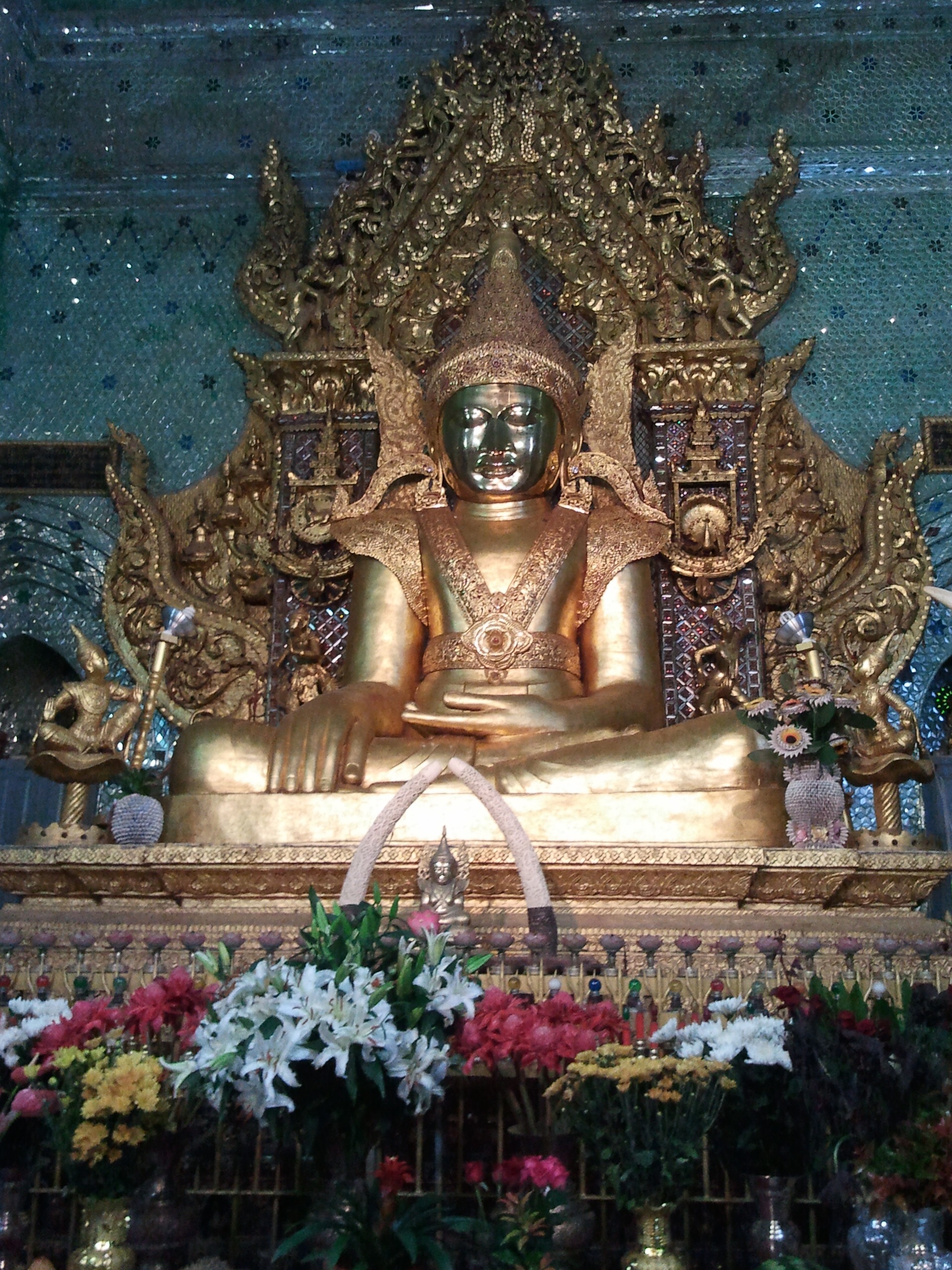 deity altar with large flower arrangement