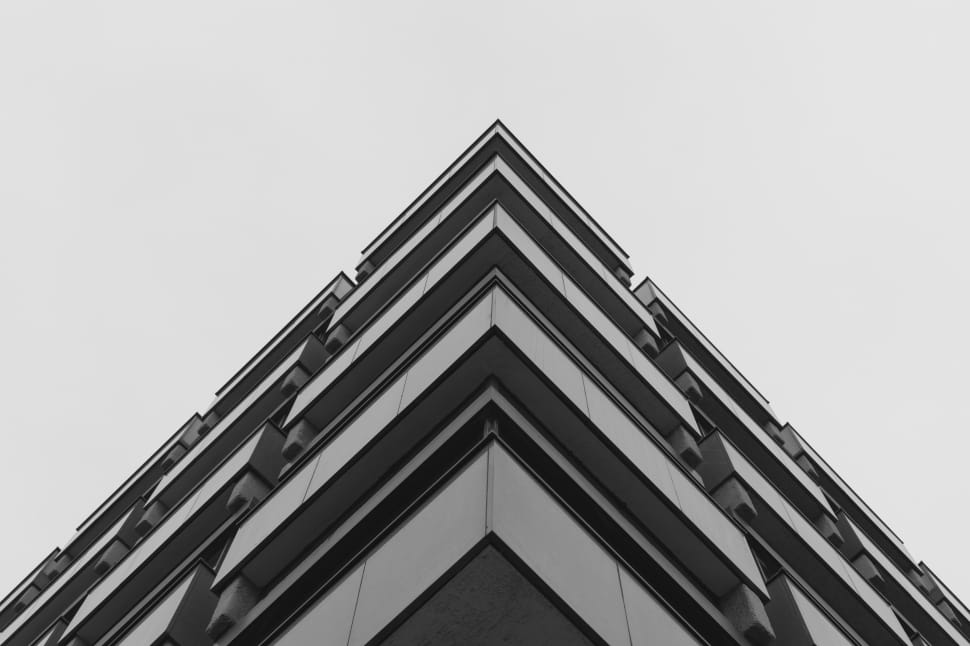 low angle view of high rise building under white clear sky during daytime preview
