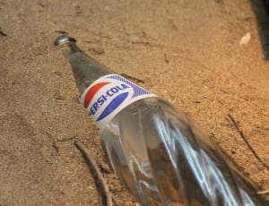 Pepsi-Cola bottle on sand thumbnail