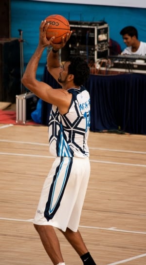 photo of basketball player holding basketball thumbnail