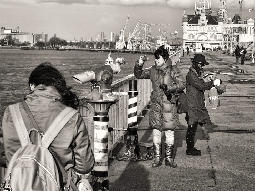 gray scale photo of people standing on dock preview