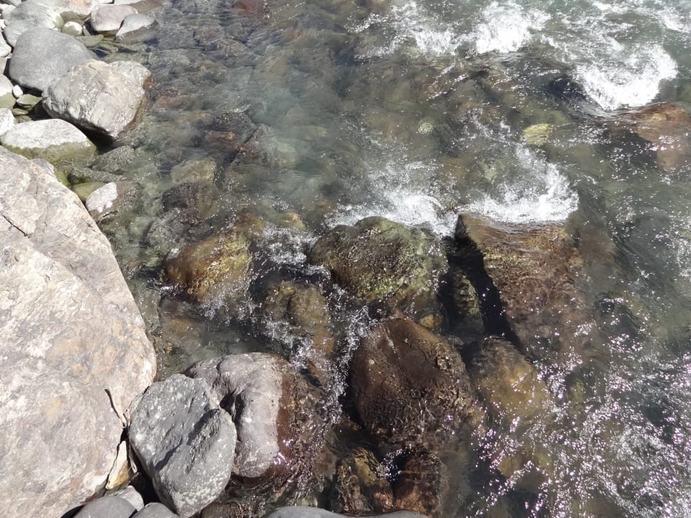 close photo of rocks in body of water preview