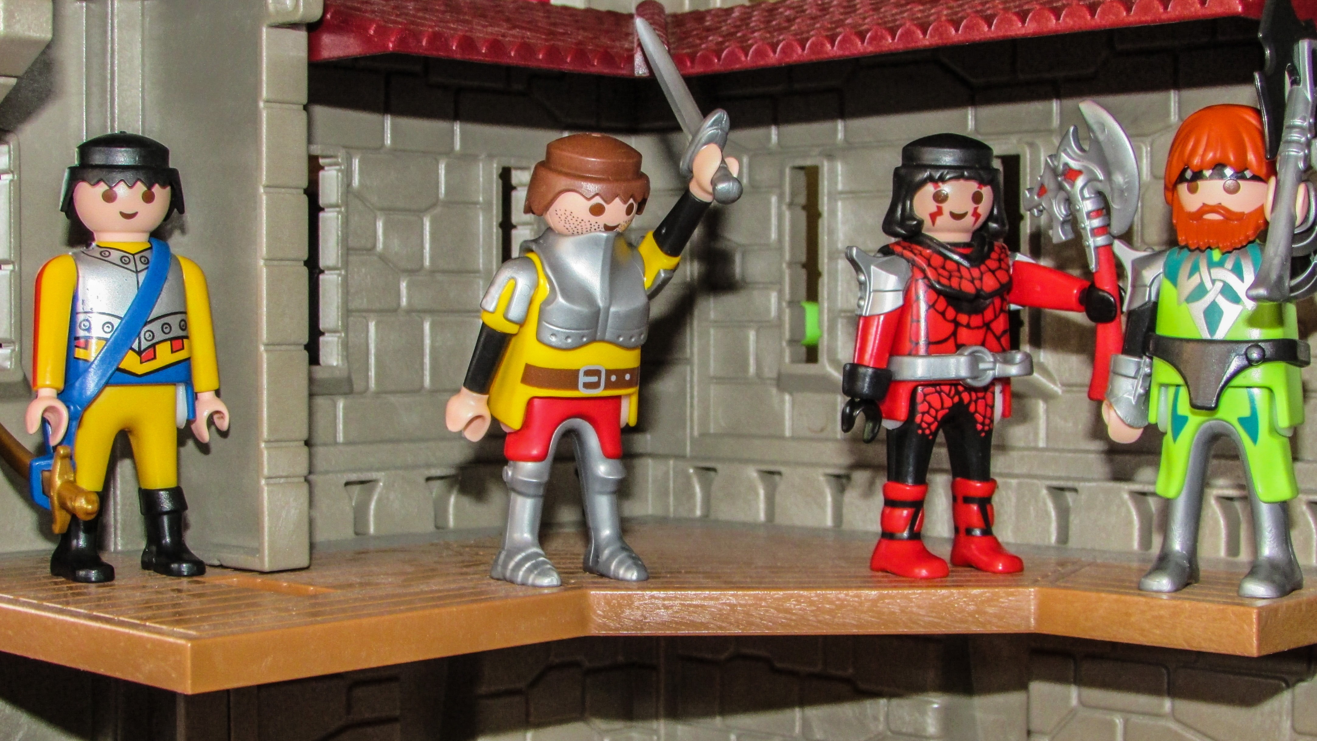 four warrior figurines with weapons