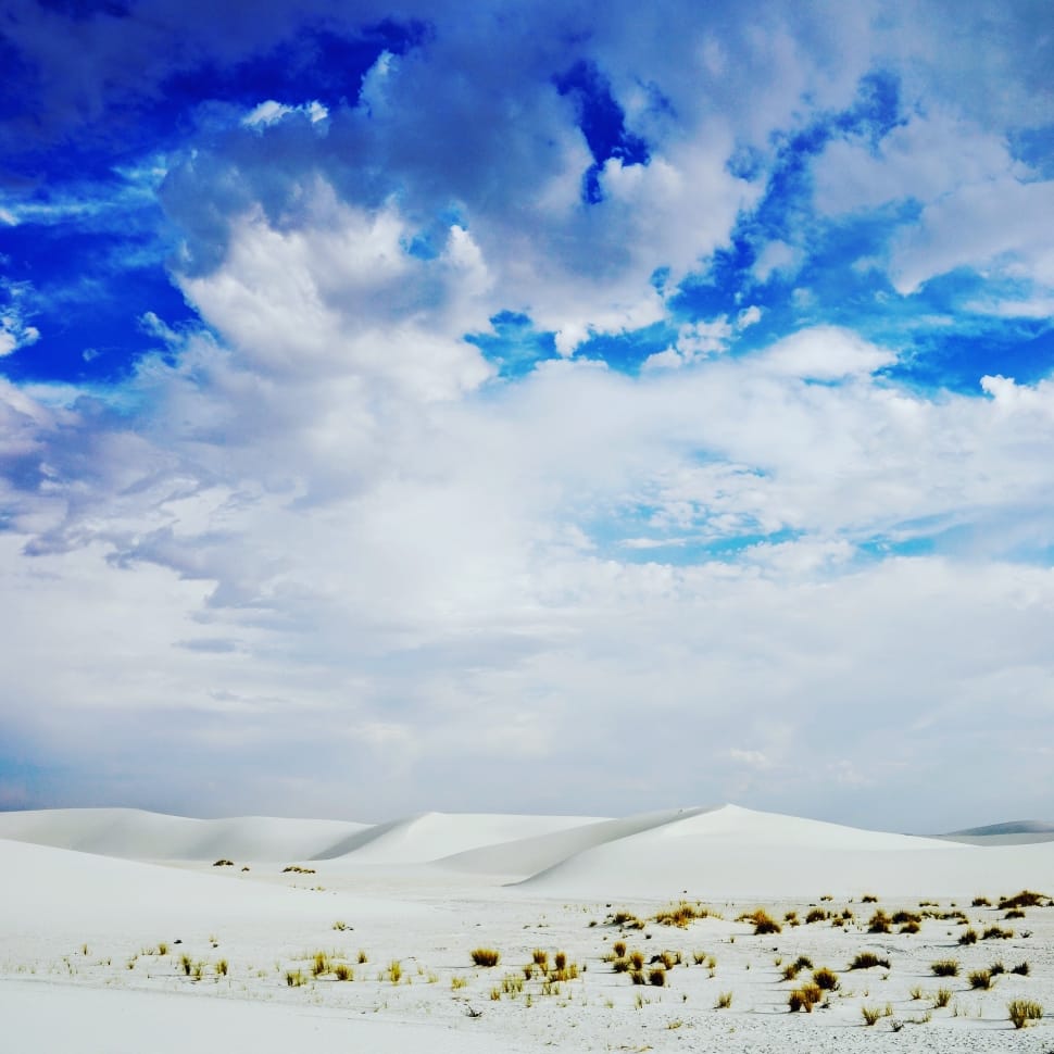 group of cumulus clouds above of white sand preview