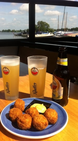 brown fritters with mayo mustard sauce with glasses of beers on side thumbnail