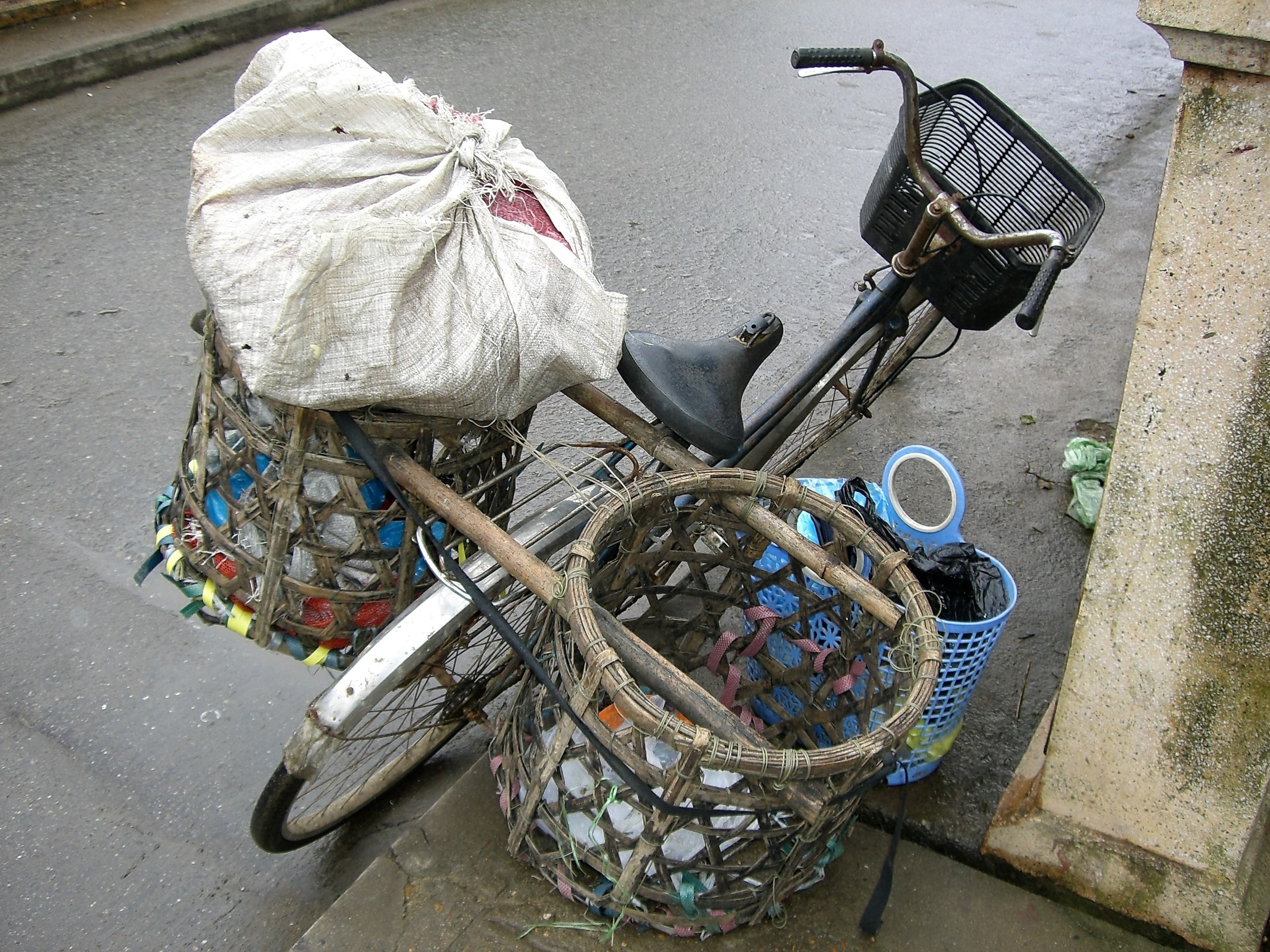 black and gray bicycle with two wooden baskets