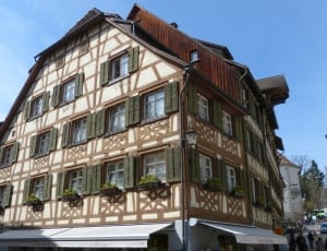 brown and white wooden 3 storey building thumbnail