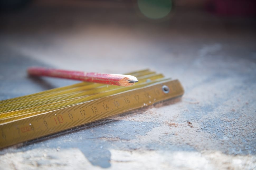 red pencil and brown wooden ruler preview