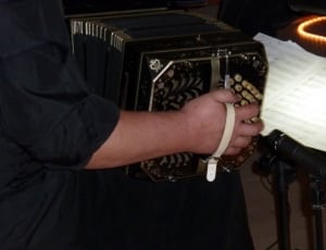 person playing black accordion thumbnail
