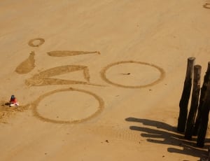 man riding bike sand-shape at daytime thumbnail