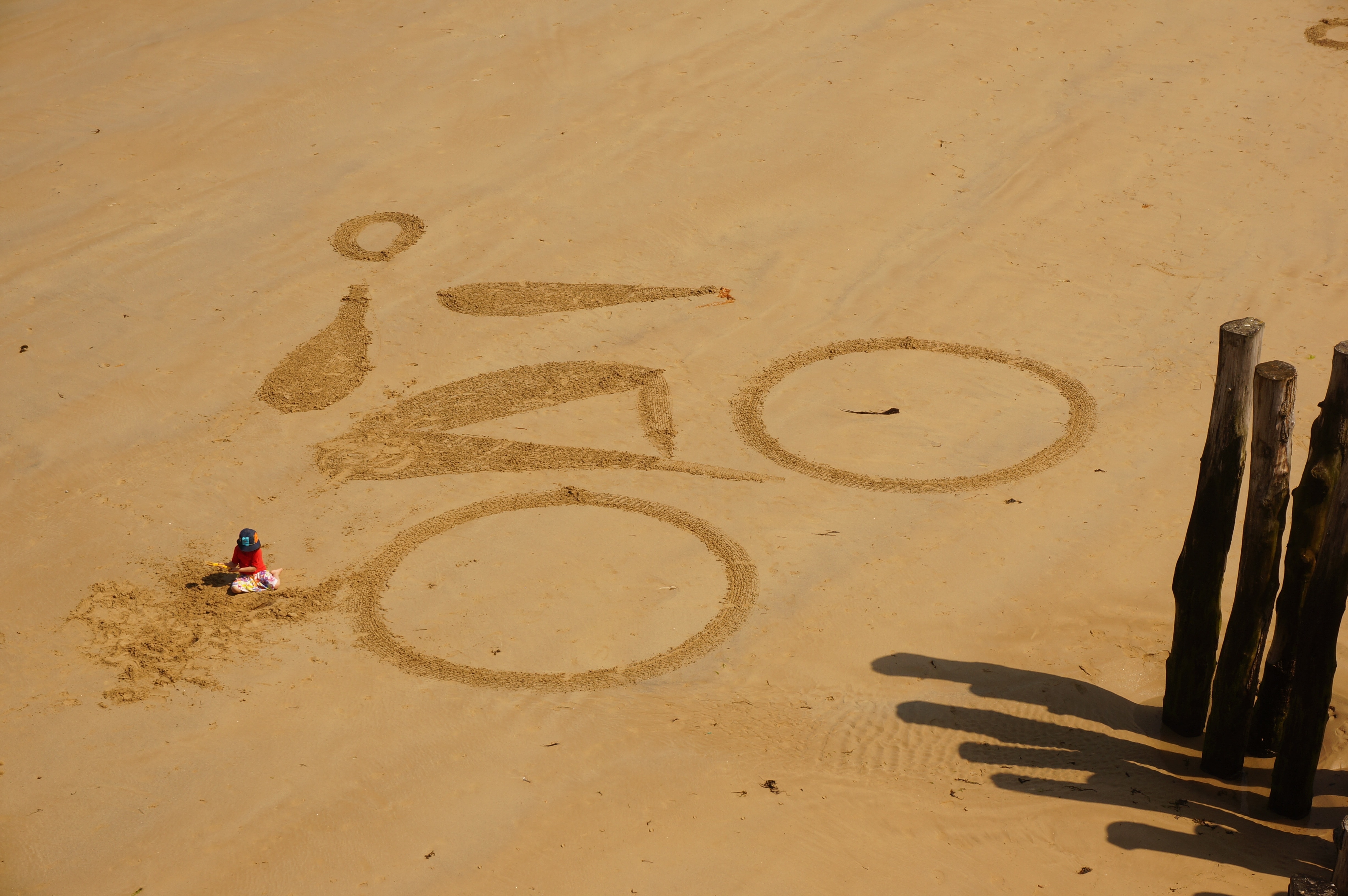 man riding bike sand-shape at daytime