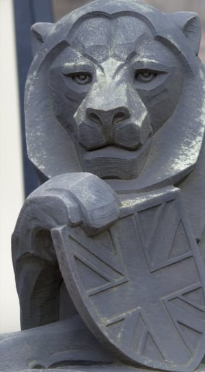 lion holding shield emblem statue thumbnail