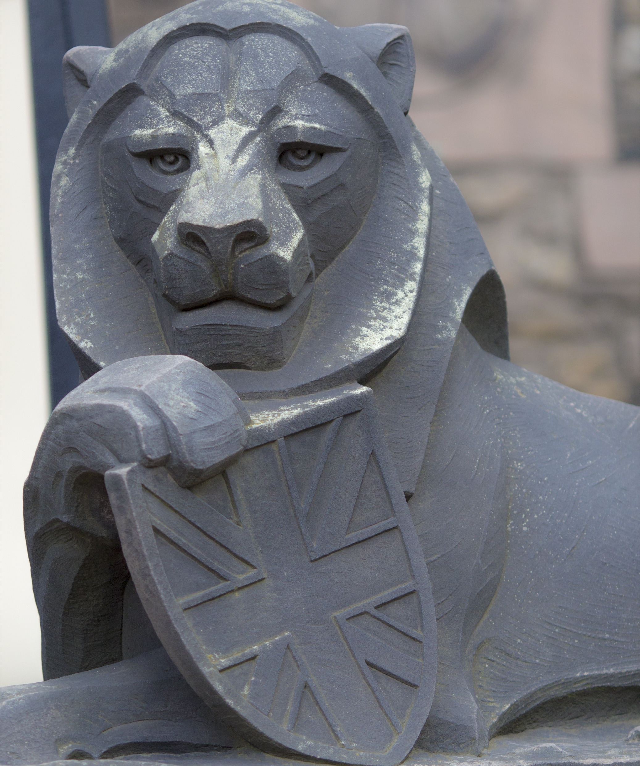 lion holding shield emblem statue
