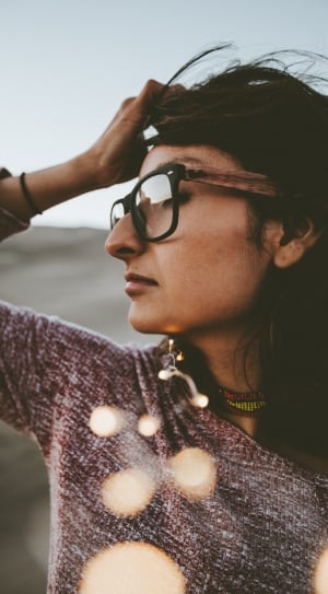 woman wearing brown and white long sleeve shirt with black and brown frame eyeglasses thumbnail