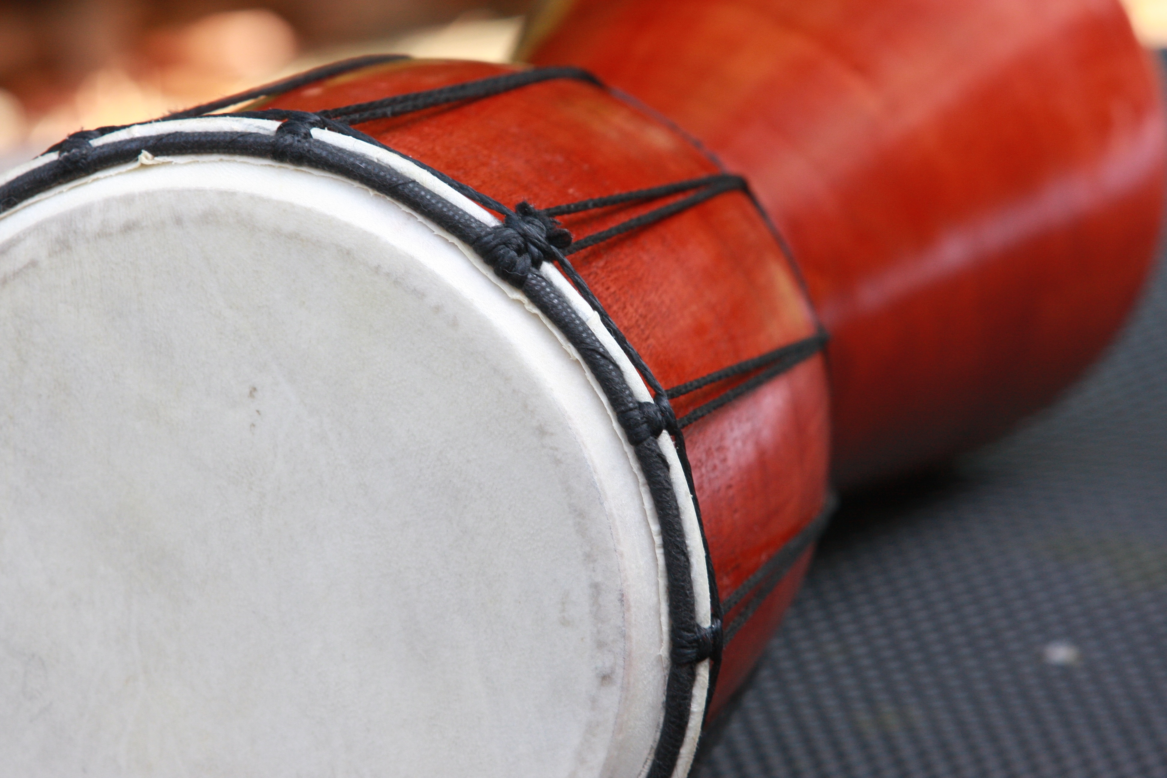 red and white wooden bongo drum