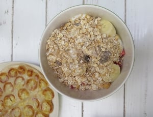 round ceramic bowl filled with oatmeal on table thumbnail