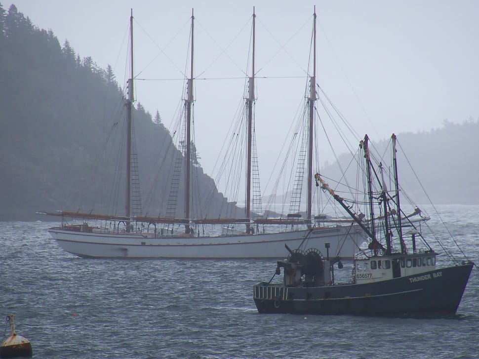 two ships on beach with mountain as background preview