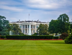 white house under blue and white cloudy sky during daytime thumbnail