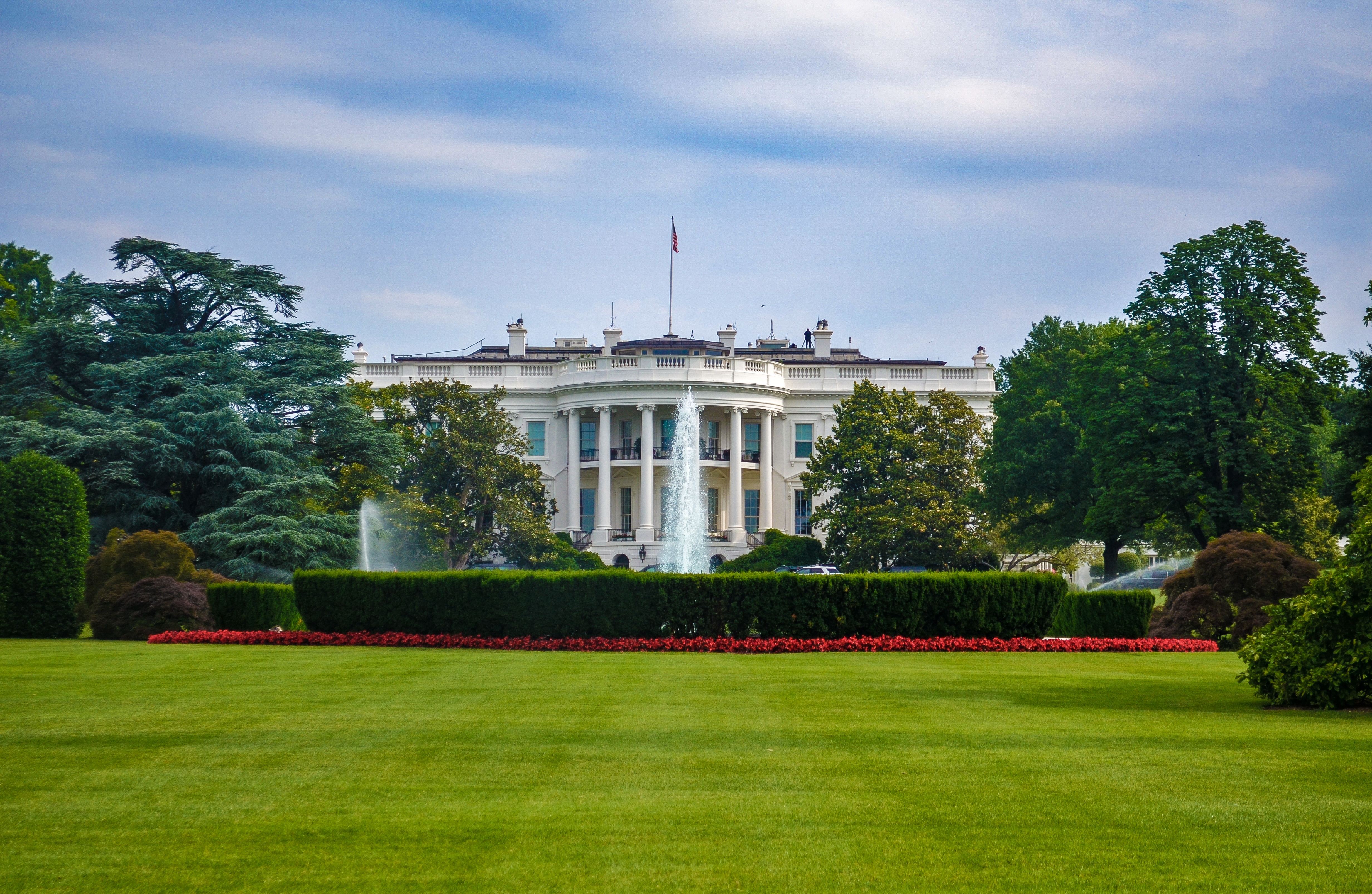 white house under blue and white cloudy sky during daytime