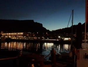 boat on dock near buildings during night thumbnail