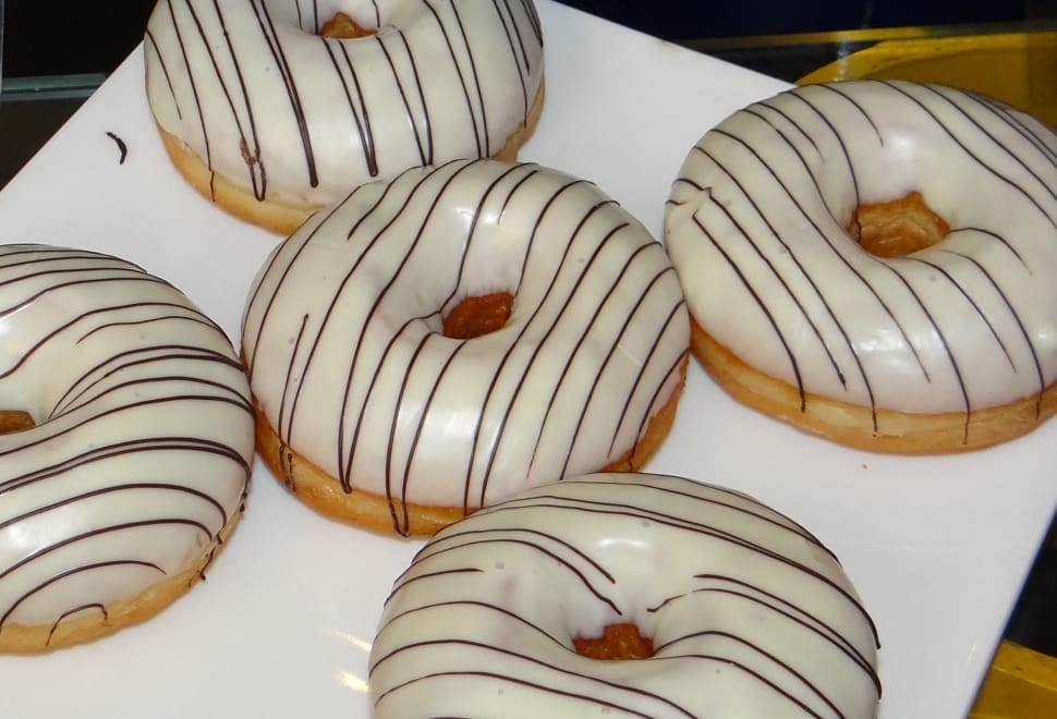 four white glazed doughnuts preview