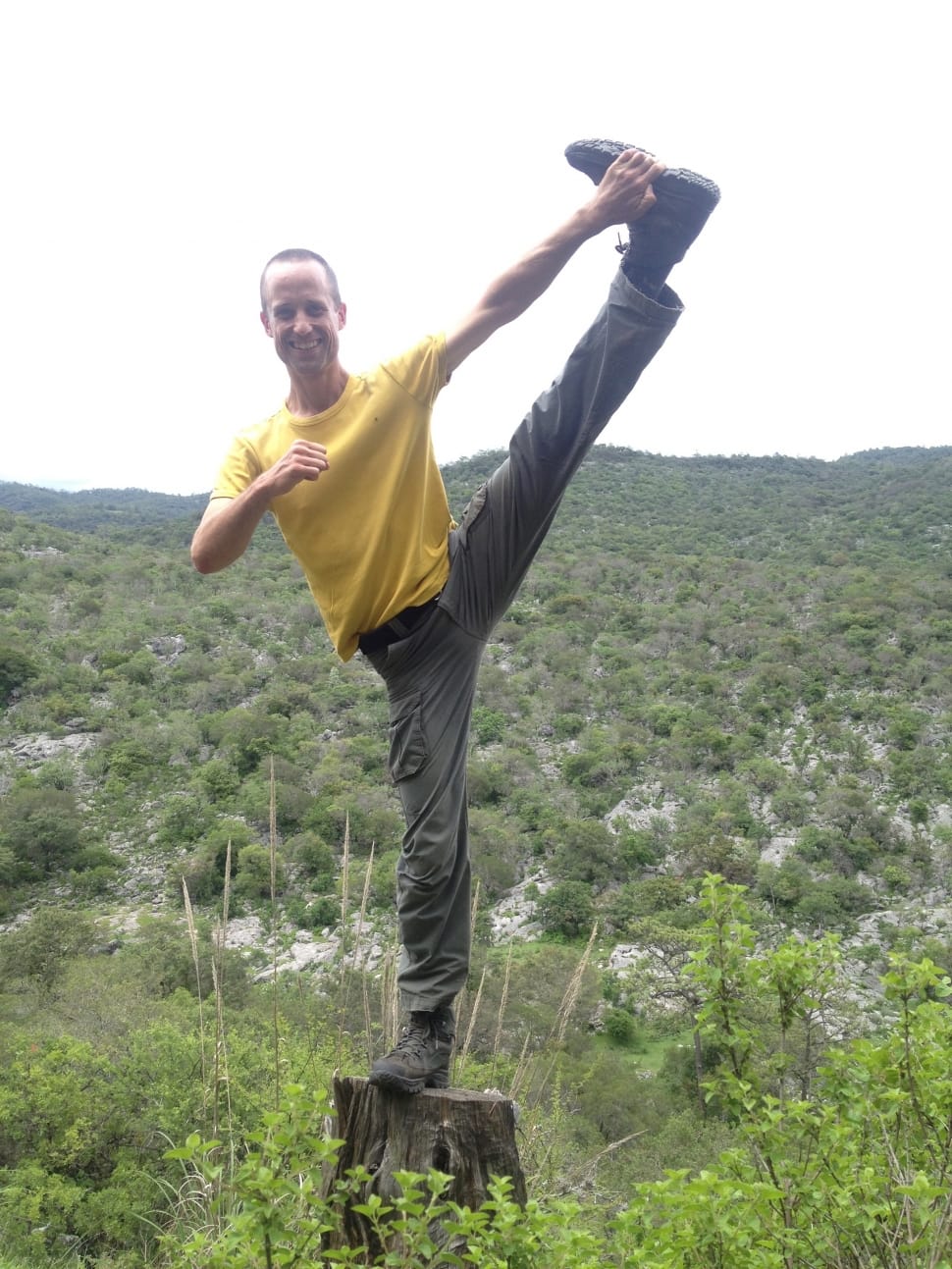 man doing yoga posture on top of log preview