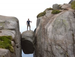 man standing on stone during daytime thumbnail