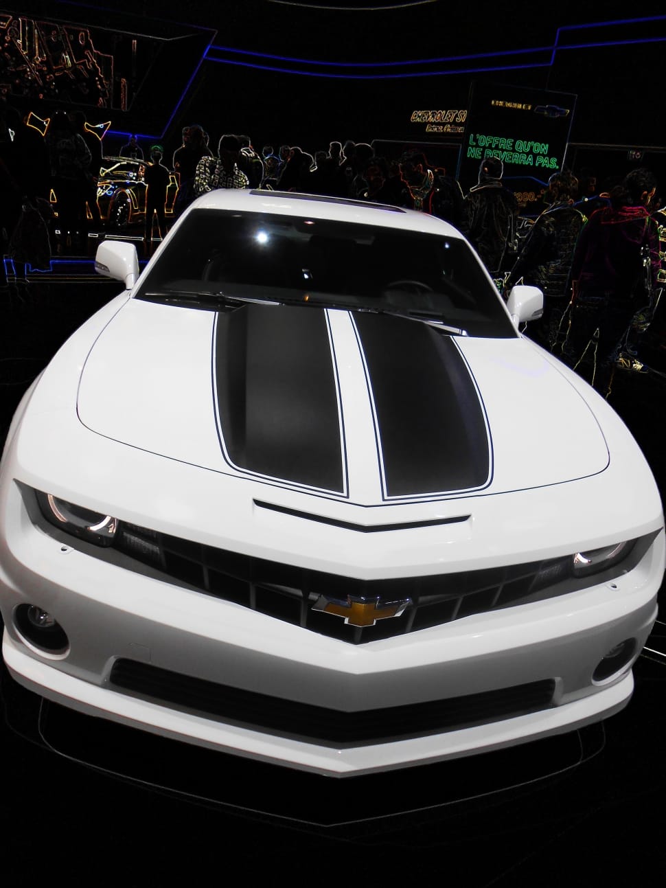 white and black Chevrolet Camaro with people gathering at motor show preview