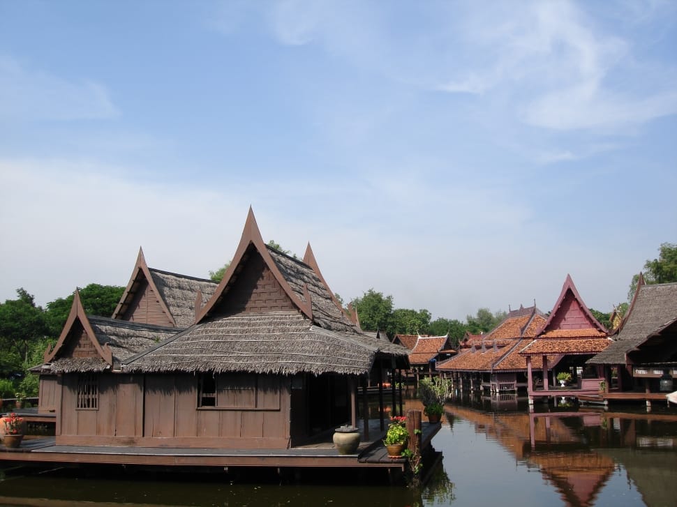 wooden houses near body of water preview