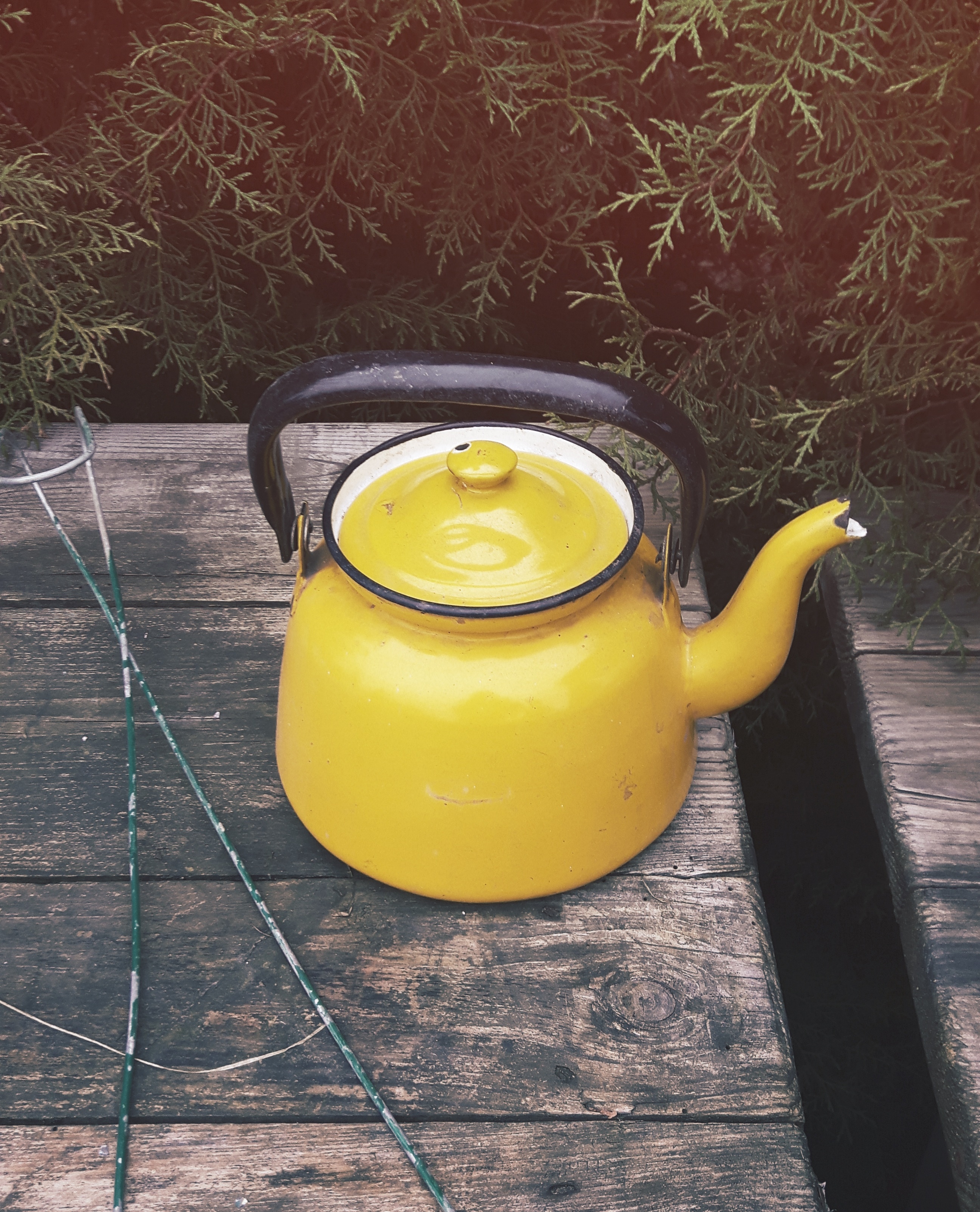 yellow and black metal teapot