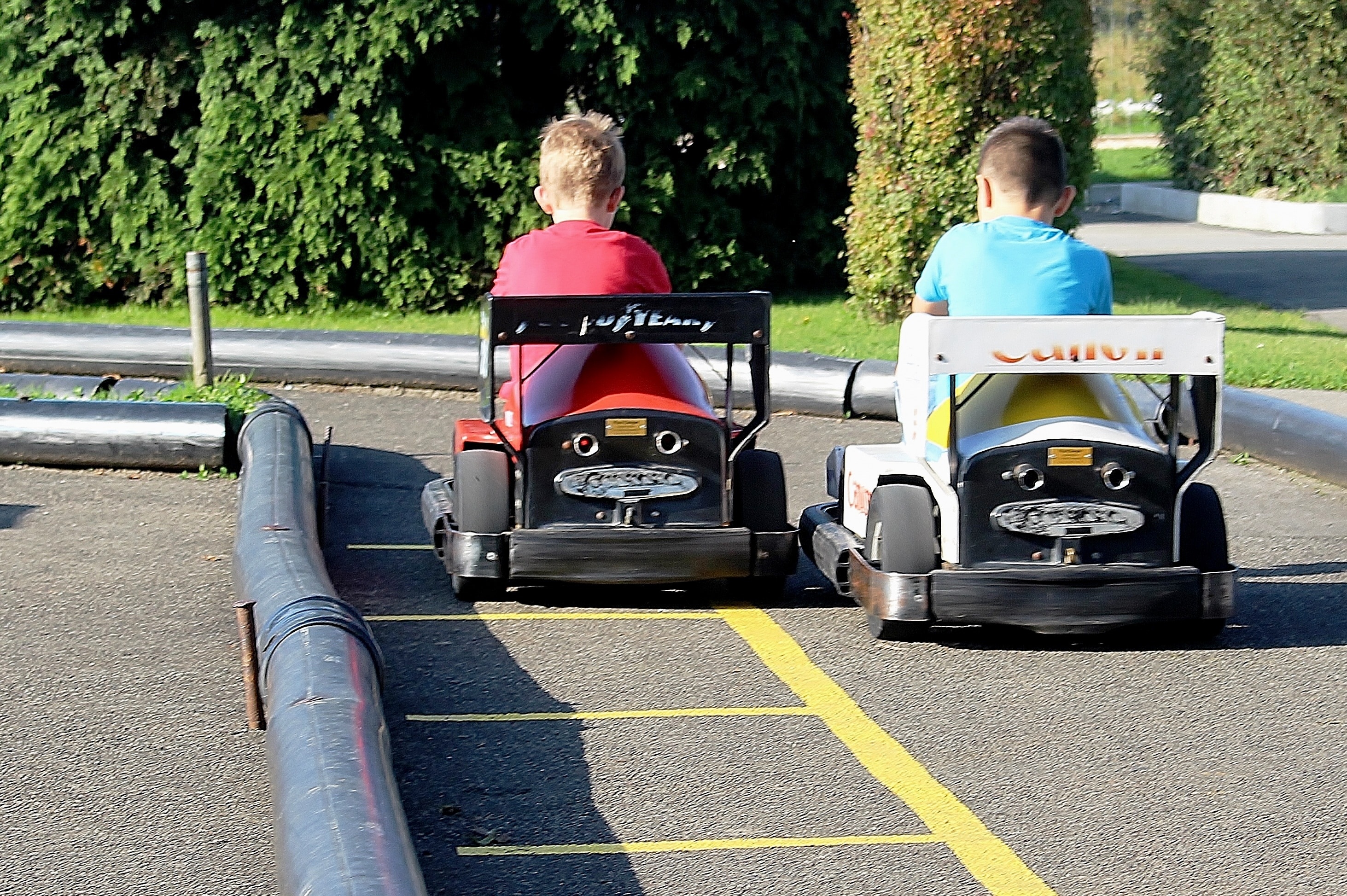 two boy's playing go kart