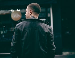 man in black leather jacket with skin tattoo thumbnail