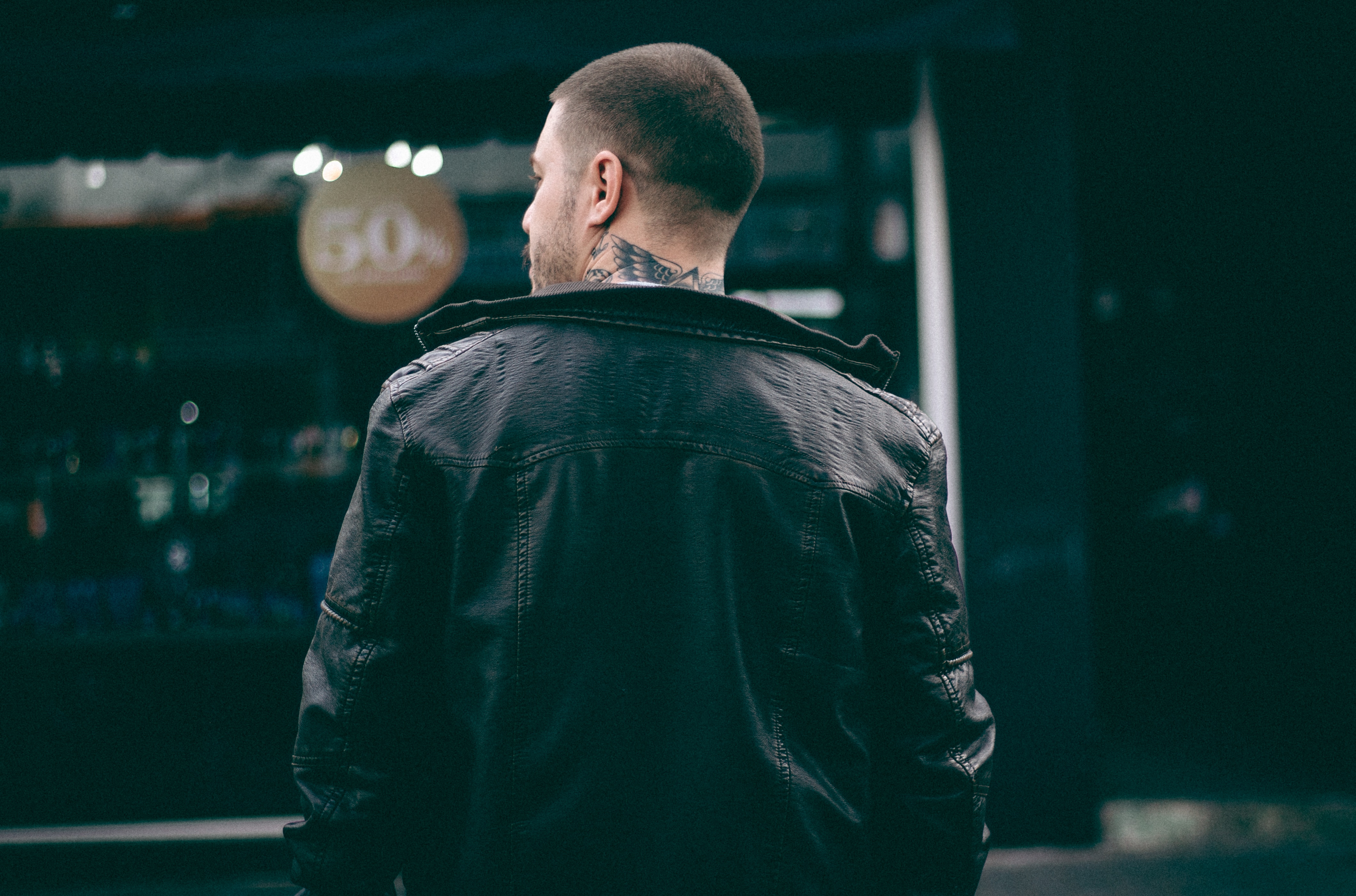 man in black leather jacket with skin tattoo