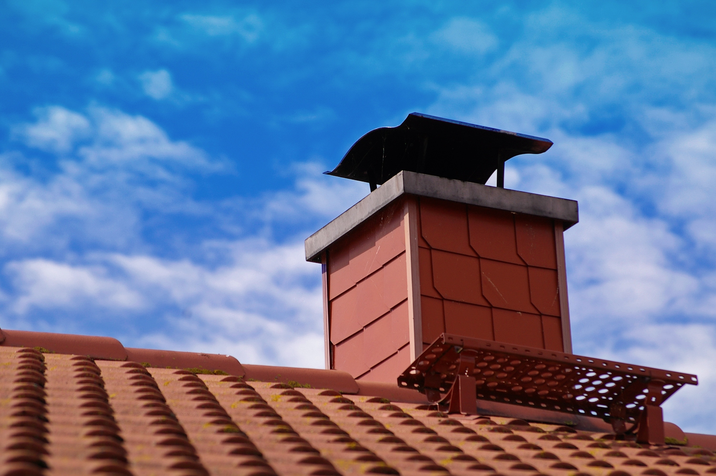 orange chimney under blue sky during day time