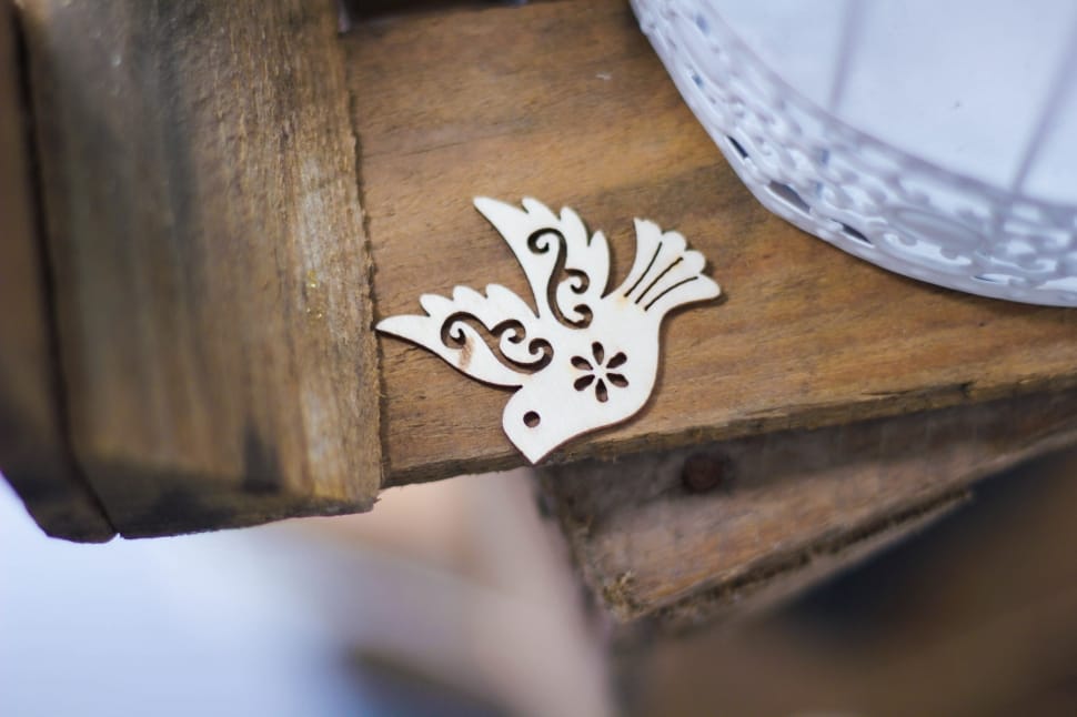 white bird decor on the brown wooden board preview