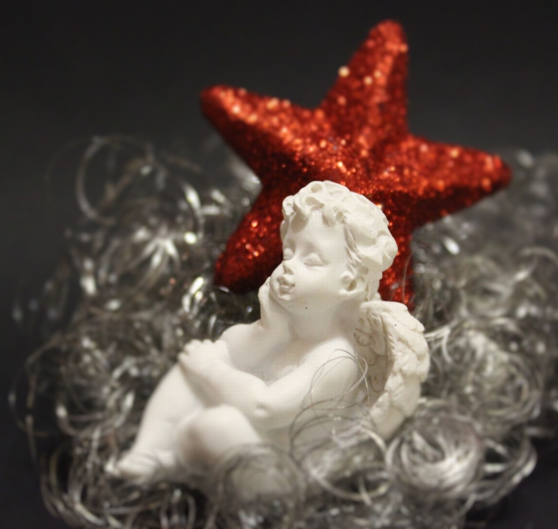white ceramic cherub sitting figurine
