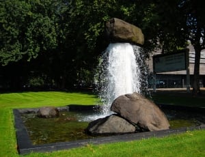 fountain under trees during daytime thumbnail