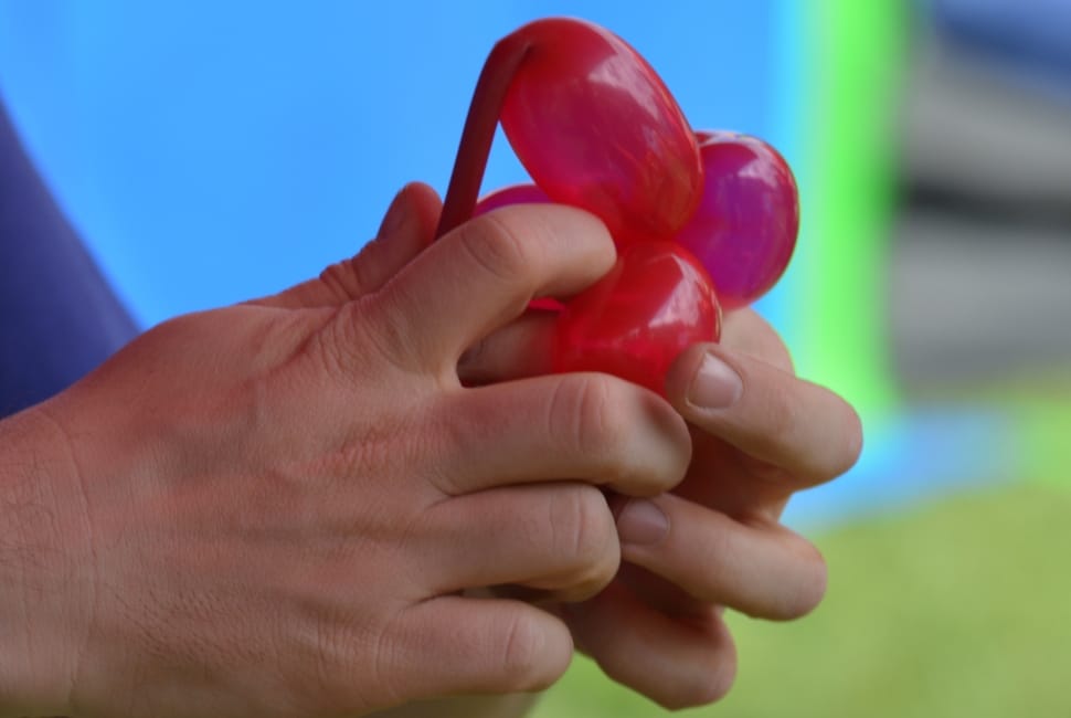 person holding a red balloon preview