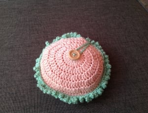 pink and green knitted round ornament thumbnail