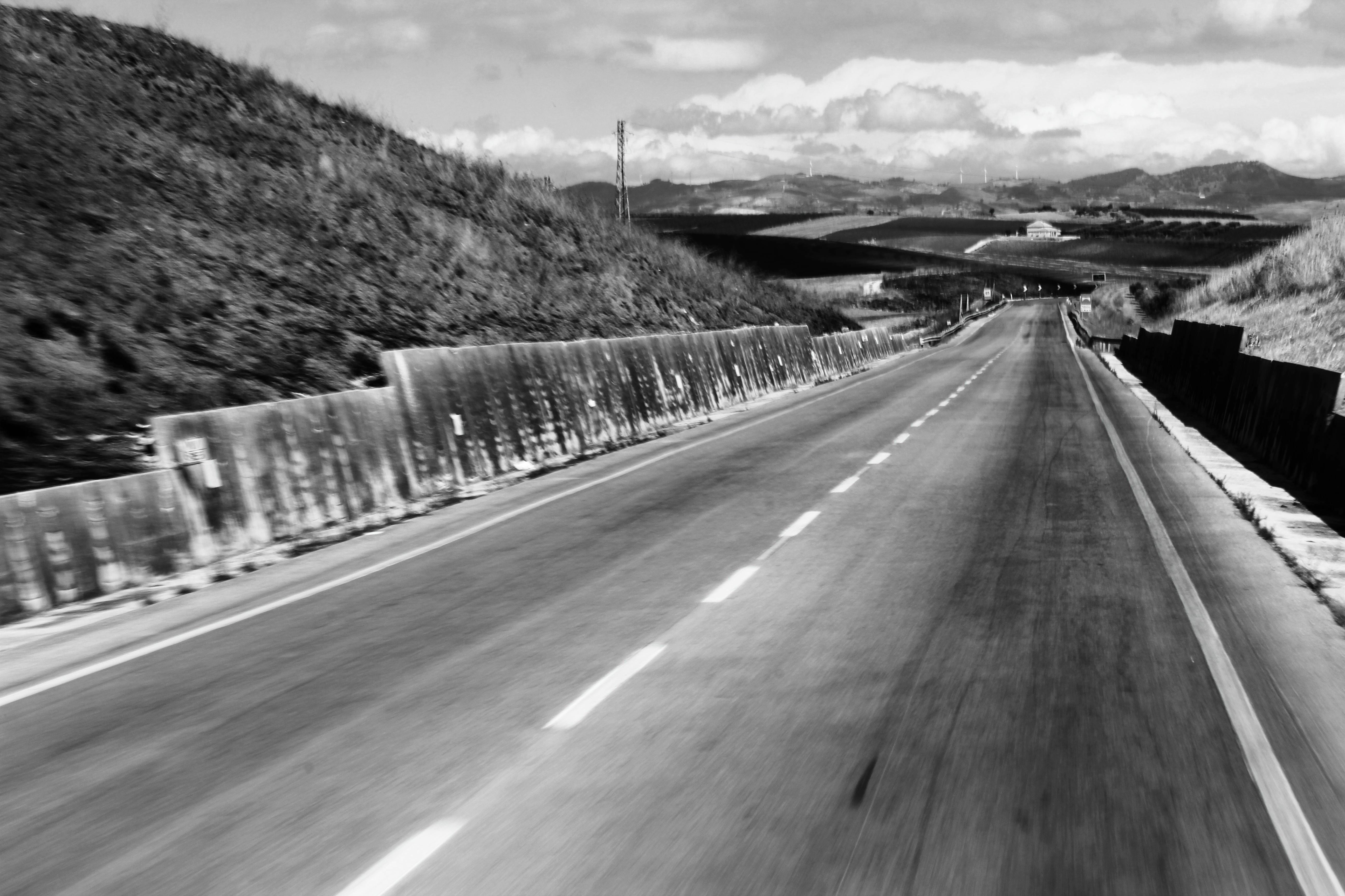 empty highway gray scale photo