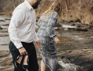 selective focus photography of man and woman near river thumbnail