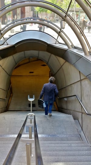 person walking down on subway staircase thumbnail