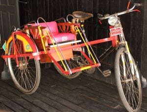 adult's red pink and yellow trike thumbnail