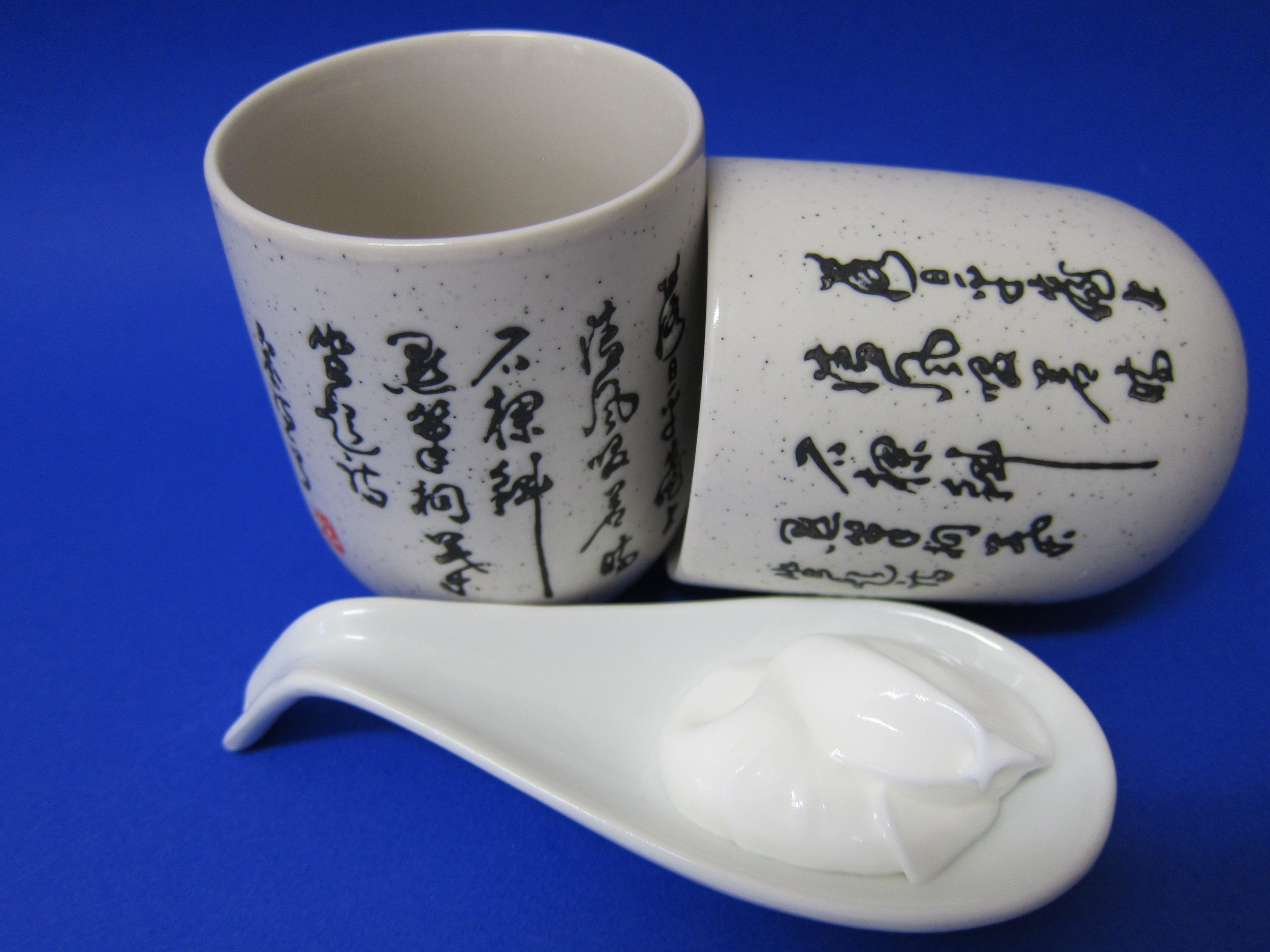 pair of white ceramic kanji print cups